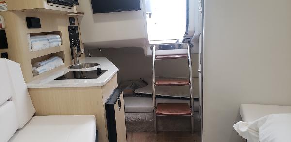 Slide: The Image of Interior of 2025 Regal 26 XO boat with kitchenette and ladder. - 19