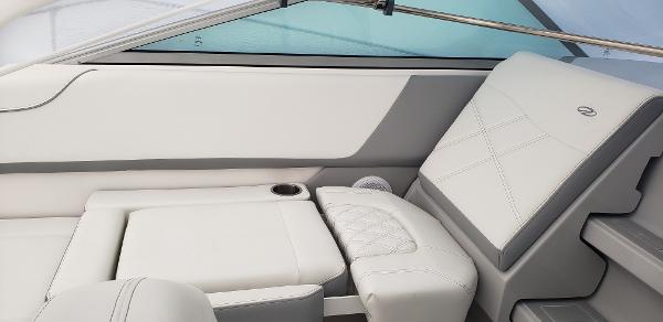 Slide: The Image of 2025 Regal 26 XO boat interior with white leather seating and cup holder. - 3