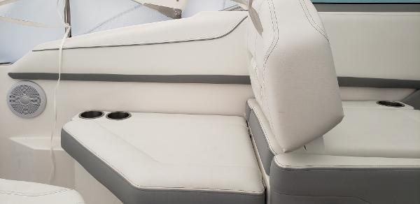Slide: The Image of 2025 Regal 26 XO boat interior with white seating and cup holders. - 6