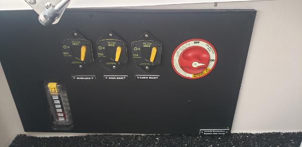 Slide: The Image of Control panel of a 2025 Regal 26 XO boat with switches and a dial. - 7