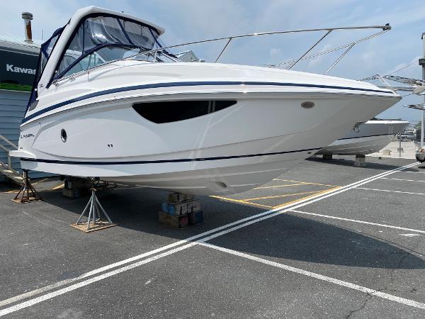 Slide: The Image of 2025 Regal 28 Express boat on stands in a marina parking lot. - 19