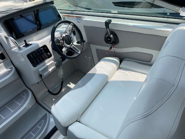 Slide: The Image of 2025 Regal 28 Express boat interior with steering wheel and control panel. - 21