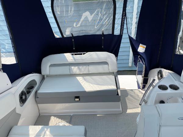 Slide: The Image of Interior of 2025 Regal 28 Express boat with seating and blue canopy. - 22