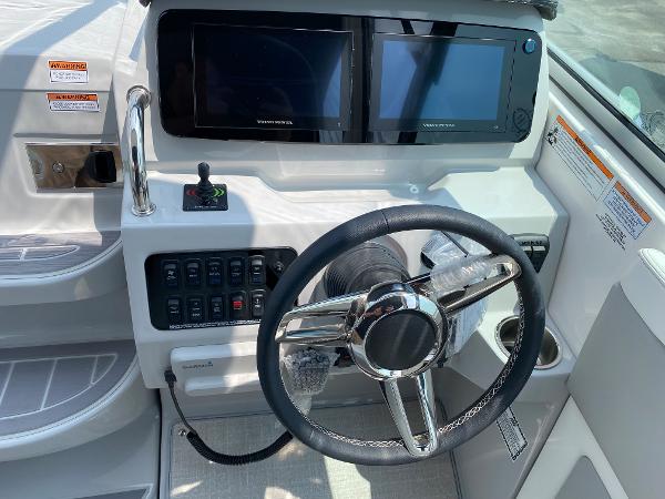 Slide: The Image of 2025 Regal 28 Express boat helm with dual displays and steering wheel. - 24