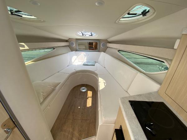 Slide: The Image of Interior of 2025 Regal 28 Express boat with modern seating and kitchenette. - 25