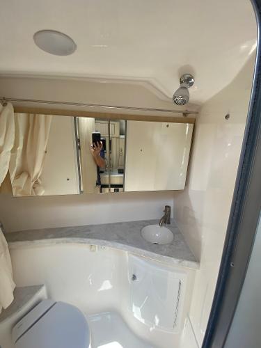 Slide: The Image of 2025 Regal 28 Express boat bathroom with modern fixtures and mirror. - 26