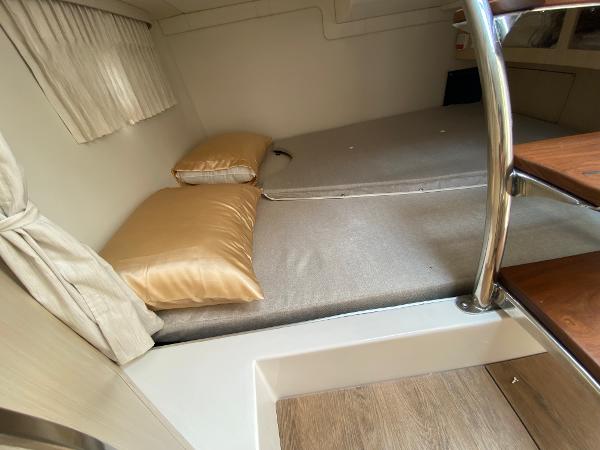 Slide: The Image of Interior cabin of 2025 Regal 28 Express with bed and pillows. - 27