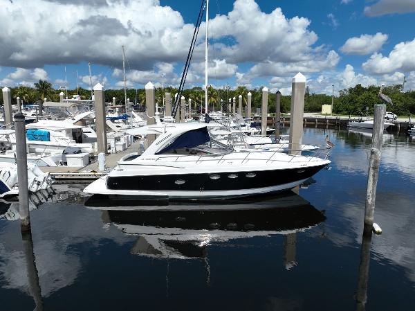 Slide: The Image of 2004 Regal 3860 Commodore yacht docked at a marina on a sunny day. - 1