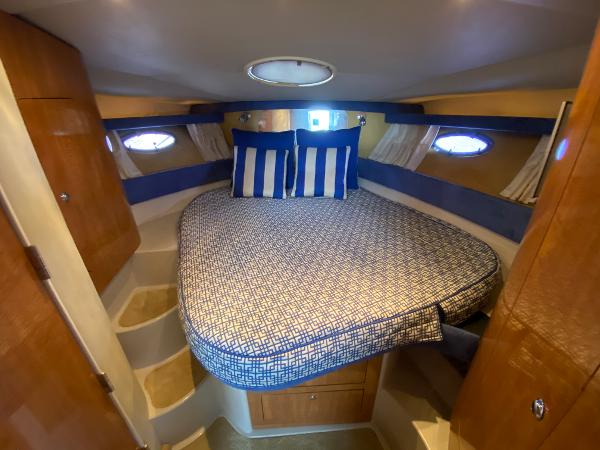 Slide: The Image of 2004 Regal 3860 Commodore yacht bedroom with blue and white bedding. - 15