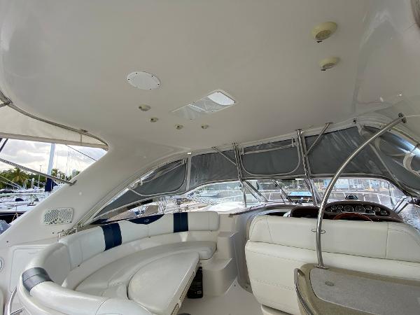 Slide: The Image of 2004 Regal 3860 Commodore yacht interior with white seating and helm station. - 21