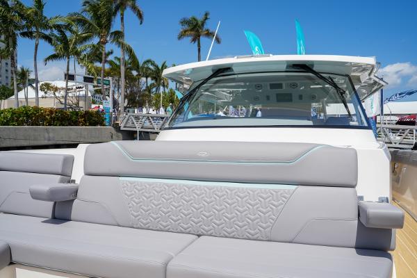 Slide: The Image of 2025 Regal 50 SAV luxury yacht with modern seating and palm trees in the background. - 25