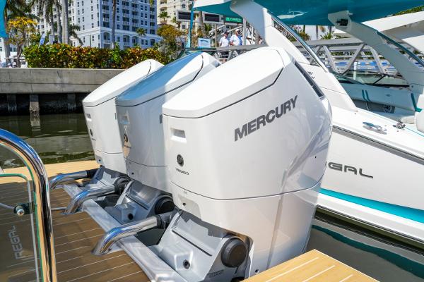 Slide: The Image of 2025 Regal 50 SAV boat with twin Mercury outboard engines docked at marina. - 8