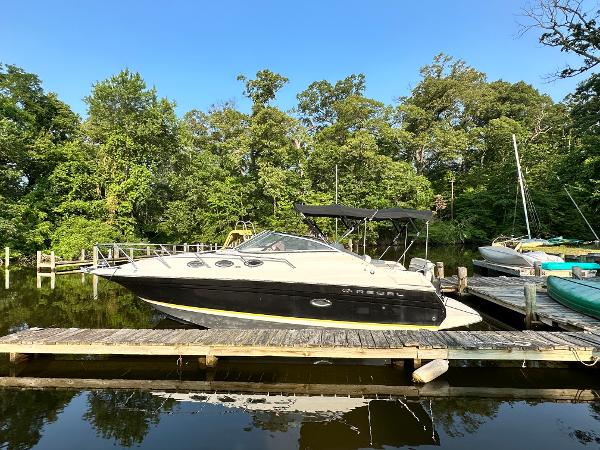 Slide: The Image of 2006 Regal Commodore boat docked in a serene marina. - 1
