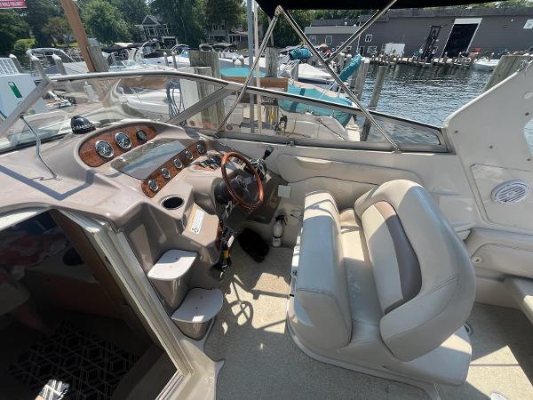 Slide: The Image of 1998 Regal 2760 boat interior with steering wheel and dashboard at marina. - 11