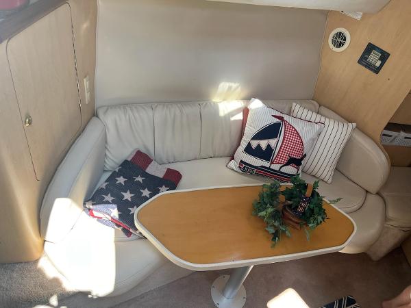 Slide: The Image of Cozy interior of 1998 Regal 2760 with cushioned seating and decorative pillows. - 15