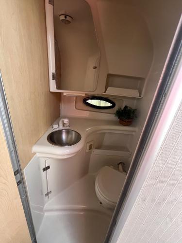 Slide: The Image of 1998 Regal 2760 boat bathroom with sink, toilet, and storage. - 20