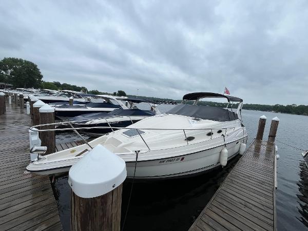Slide: The Image of 1998 Regal 2760 boat docked at a marina on a cloudy day. - 3