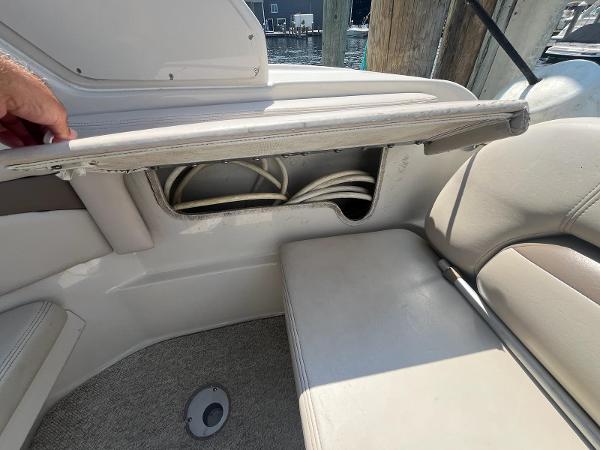 Slide: The Image of 1998 Regal 2760 boat interior with open storage compartment and visible wiring. - 8
