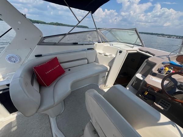 Slide: The Image of 1998 Regal 2760 boat interior with seating, steering wheel, and lake view. - 9