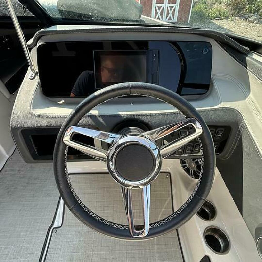 Slide: The Image of Helm Steering wheel, gps screen, and DC controls on this 2021 Regal LS4 for sale by Lucas Sochacki at Parma Marine (440) 915-8995 - 5184944