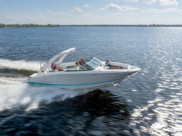 Slide: The Image of 2024 Regal LS6 speedboat cruising on a sunny lake with passengers. - 1