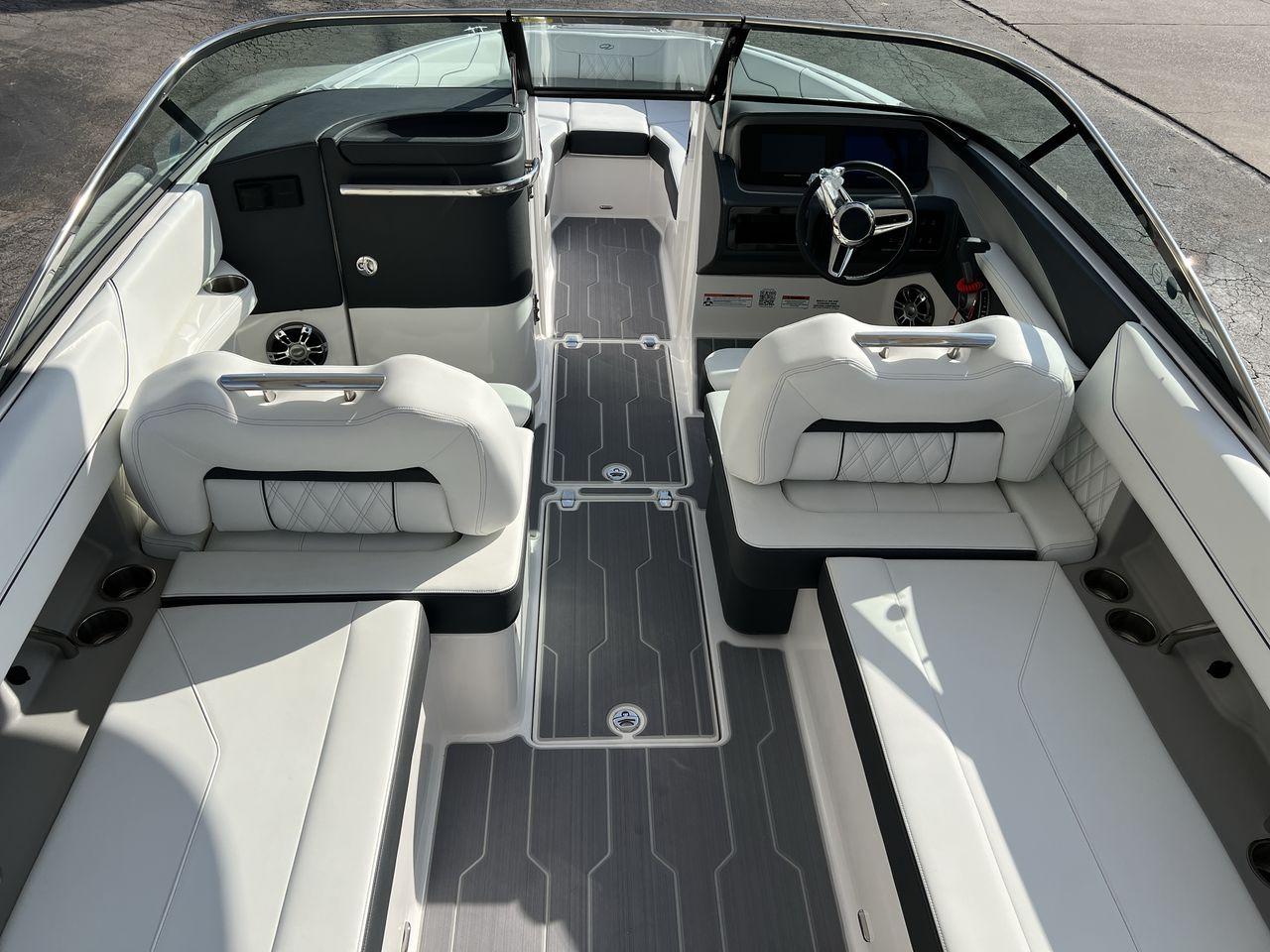 Slide: The Image of 2023 Regal LS6 Surf boat interior with luxurious seating and modern dashboard. - 10
