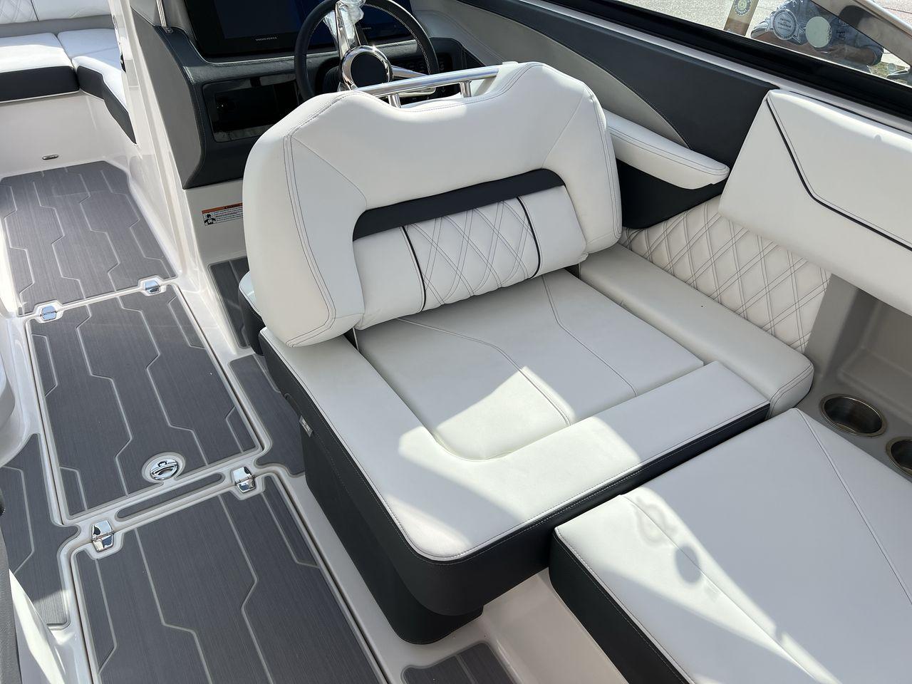 Slide: The Image of 2023 Regal LS6 Surf boat interior with white leather seats and modern design. - 12