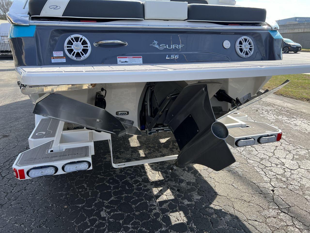 Slide: The Image of 2023 Regal LS6 Surf boat rear view with propeller and swim platform. - 16