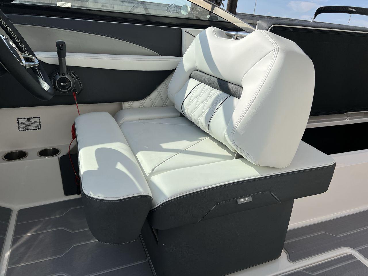 Slide: The Image of 2023 Regal LS6 Surf boat interior with luxurious white leather seating and modern controls. - 19