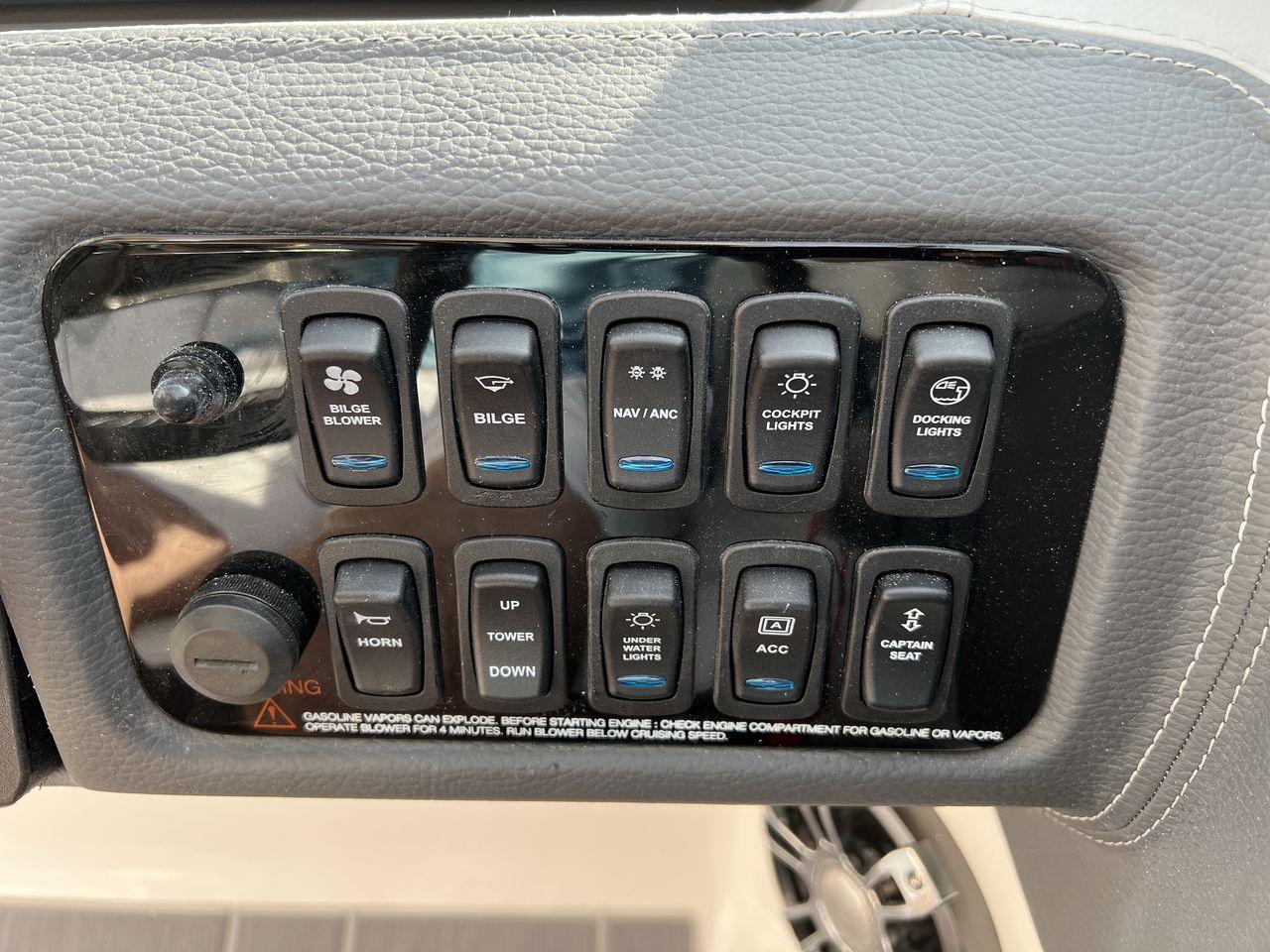 Slide: The Image of Control panel of 2023 Regal LS6 Surf boat with various switches and buttons. - 22