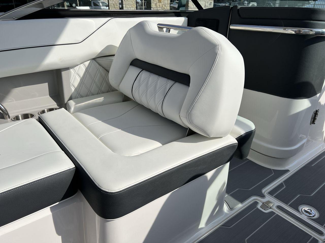 Slide: The Image of 2023 Regal LS6 Surf boat interior with luxurious white and black seating. - 25