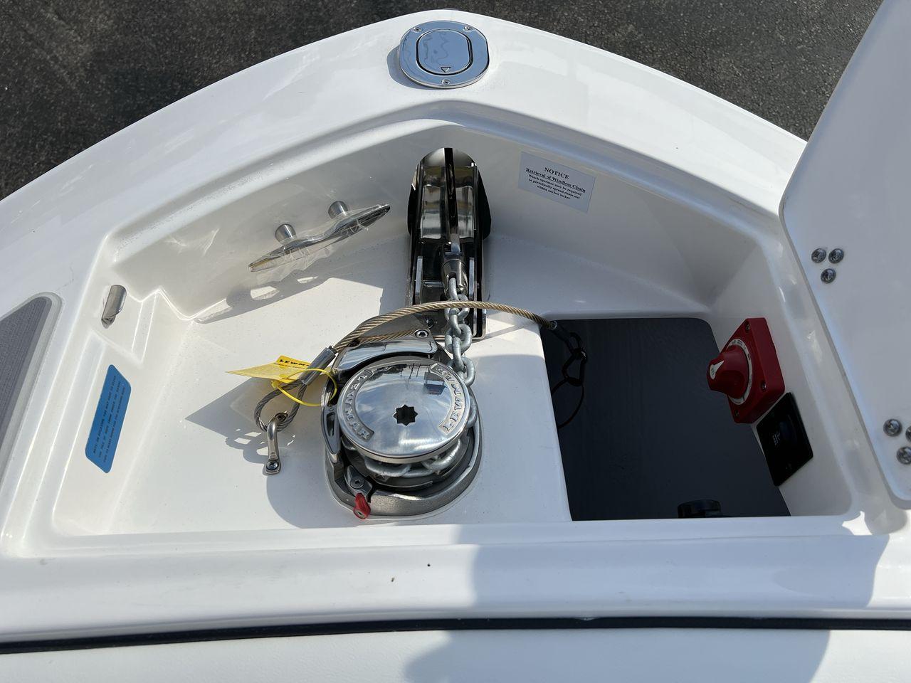Slide: The Image of 2023 Regal LS6 Surf boat anchor compartment with winch and control panel. - 26