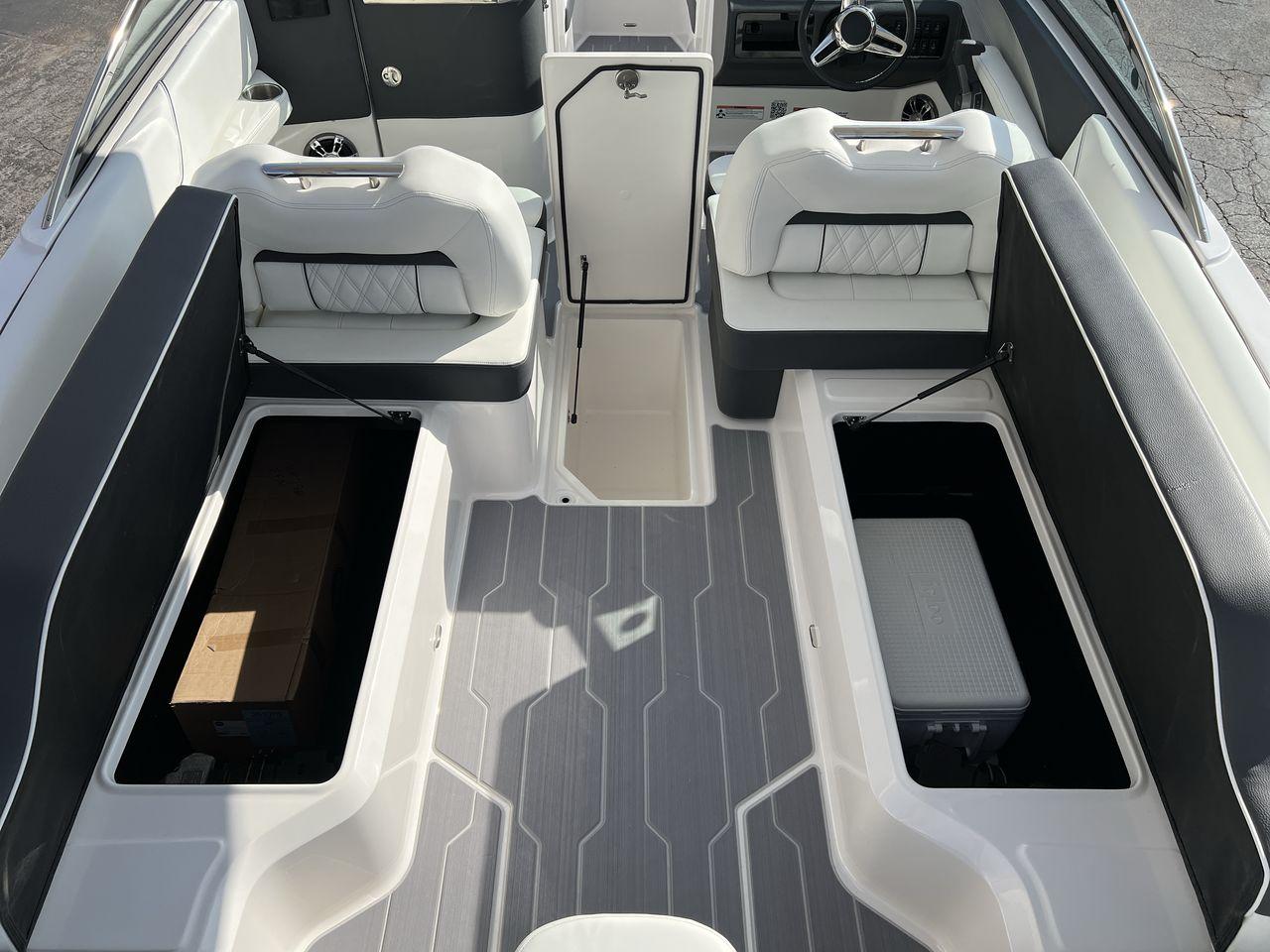 Slide: The Image of 2023 Regal LS6 Surf boat interior with open storage compartments and seating. - 29