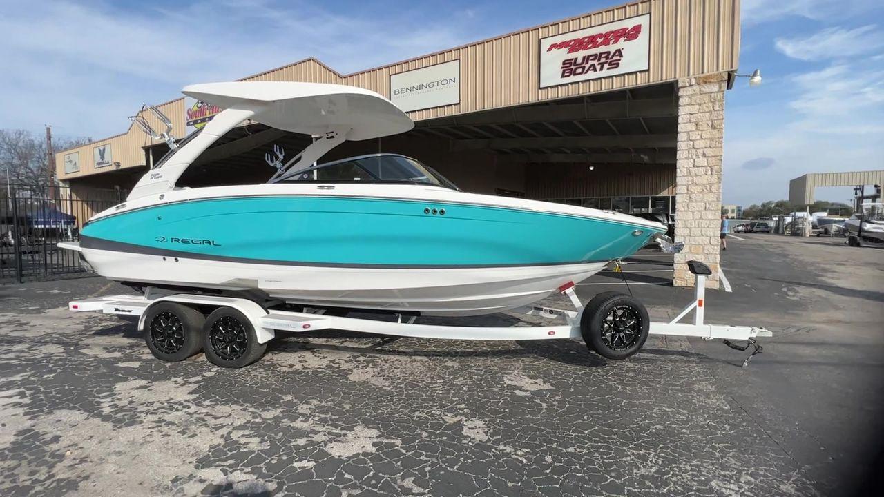 Slide: The Image of 2023 Regal LS6 Surf boat on trailer outside dealership. - 3