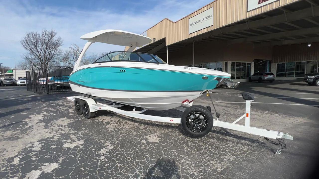 Slide: The Image of 2023 Regal LS6 Surf boat on trailer outside dealership. - 4