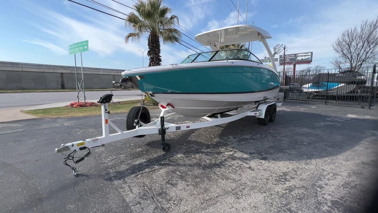 Slide: The Image of 2023 Regal LS6 Surf boat on a trailer in a parking lot. - 6
