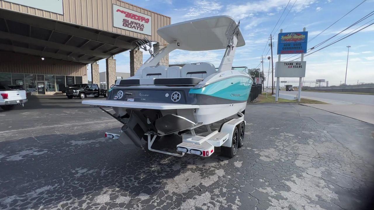 Slide: The Image of 2023 Regal LS6 Surf boat on a trailer at a dealership. - 8