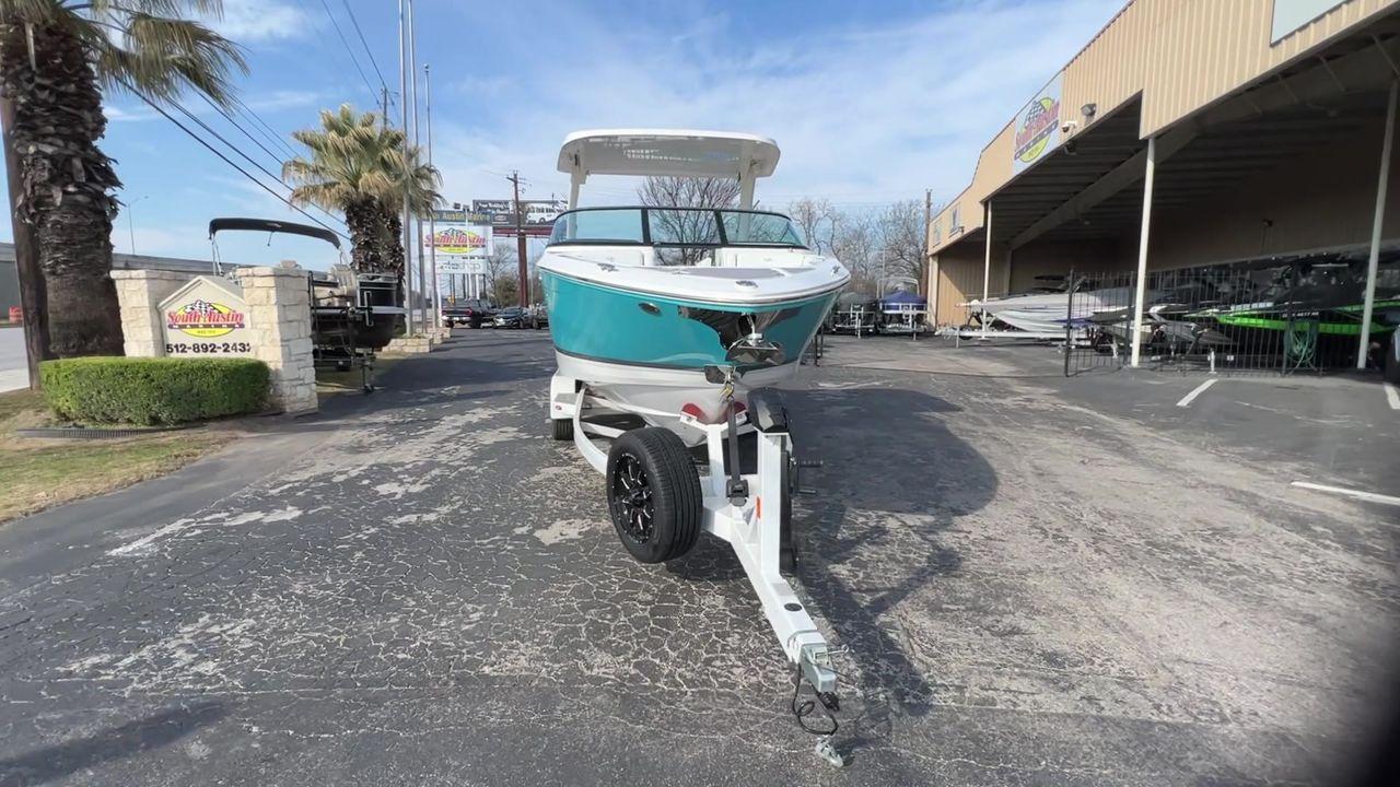 Slide: The Image of 2023 Regal LS6 Surf boat on a trailer at a dealership. - 9