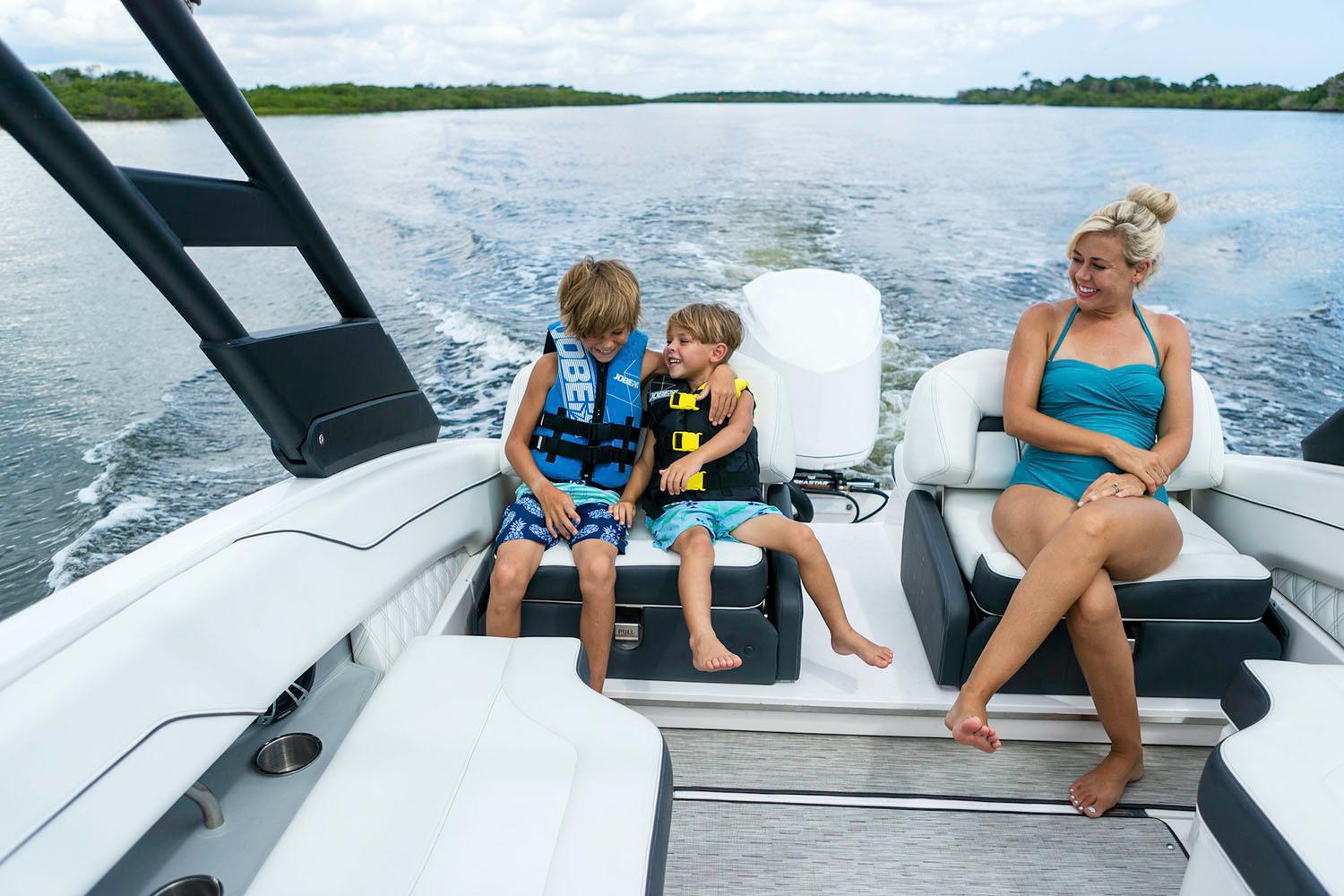 Slide: The Image of Family enjoying a ride on a 2024 Regal LX4 boat. - 13