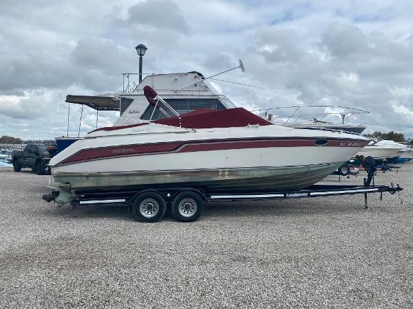 Slide: The Image of 1992 Regal Ventura boat on a trailer in a marina. - 1