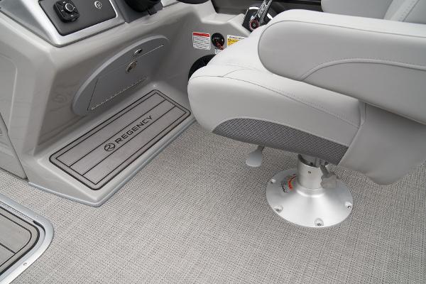 Slide: The Image of 2024 Regency 230 LE3 Sport boat interior with captain's chair and console. - 28