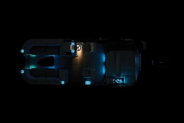 Slide: The Image of 2024 Regency 230 LE3 Sport pontoon boat with ambient blue lighting at night. - 45
