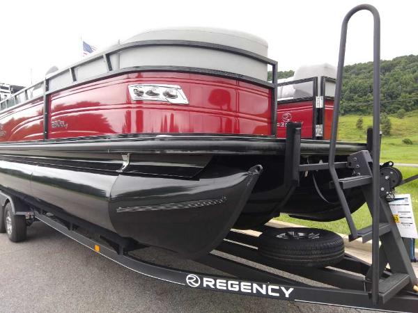 Slide: The Image of 2024 Regency 250 DL3 pontoon boat on trailer, red and black design. - 1