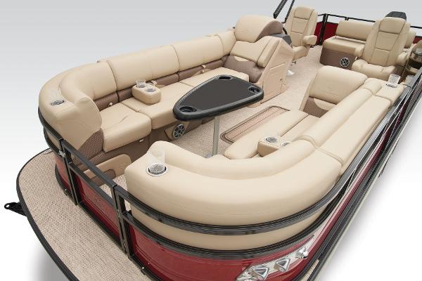 Slide: The Image of 2024 Regency 250 DL3 pontoon boat with luxurious beige seating and black accents. - 24