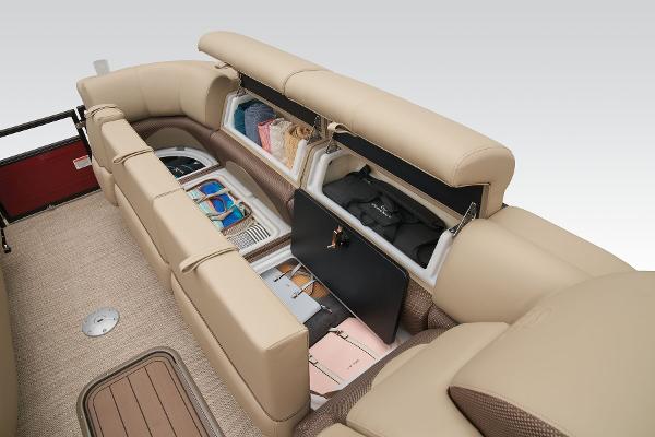 Slide: The Image of 2024 Regency 250 DL3 boat interior storage compartments with beige seating. - 26