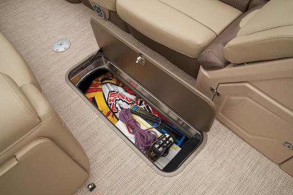 Slide: The Image of 2024 Regency 250 DL3 under-seat storage compartment with various items. - 29