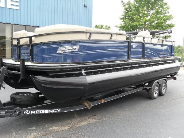 Slide: The Image of 2024 Regency 250 DL3 pontoon boat on trailer, blue and black design. - 3