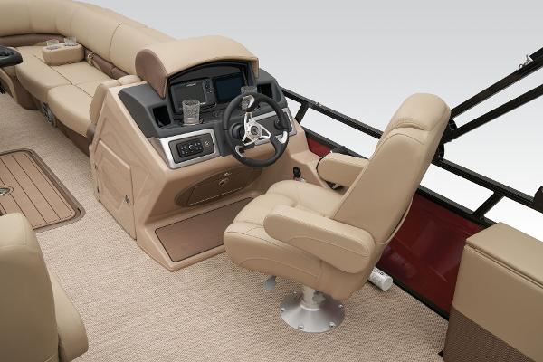 Slide: The Image of 2024 Regency 250 DL3 boat interior with beige captain's chair and control console. - 32
