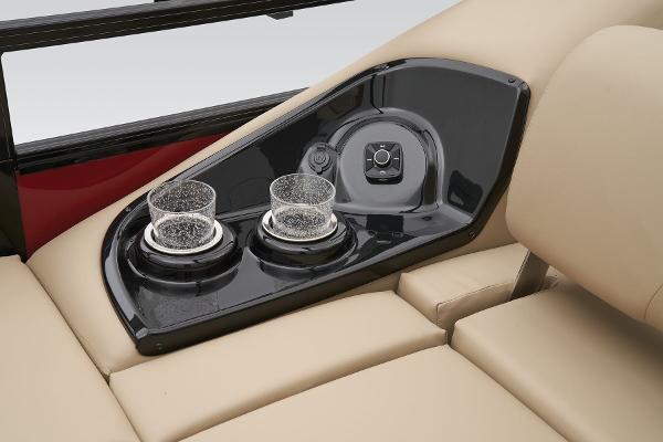 Slide: The Image of 2024 Regency 250 DL3 boat cup holders and control panel on beige seating. - 40