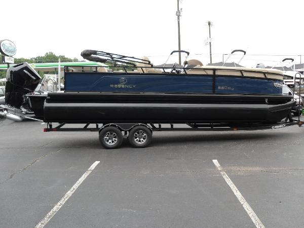 Slide: The Image of 2024 Regency 250 DL3 pontoon boat on trailer in parking lot. - 8